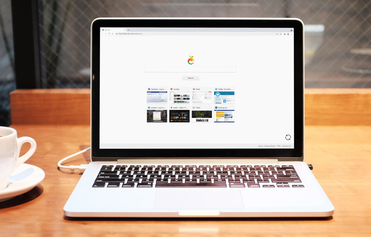 Fresh-tab.info on a laptop screen.